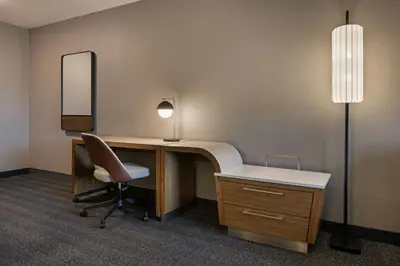 an office with a desk and a chair and a mirror at Courtyard by Marriott Sacramento Midtown in Sacramento