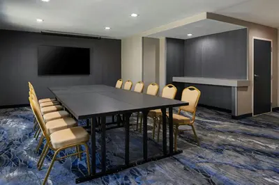 a conference room with a black table and chairs at Fairfield Inn Sacramento Cal Expo in Sacramento