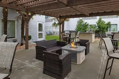 a patio with chairs and a table with a fire pit at Courtyard by Marriott Sacramento Cal Expo in Sacramento