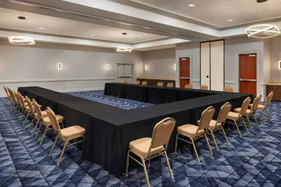 a conference room with a black table and chairs at Courtyard by Marriott Sacramento Cal Expo in Sacramento