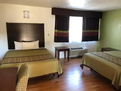 a hotel room with two beds and a window at Americas Best Value Inn Visalia in Visalia