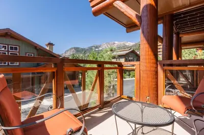 a patio with chairs and a table on a deck at Juniper Crest 3 in Old Mammoth