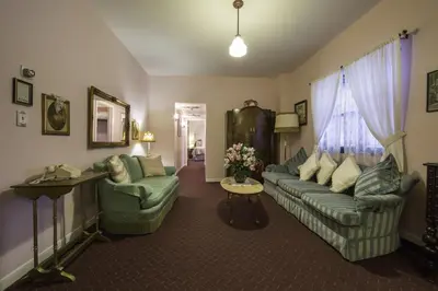 a living room with a couch and two chairs at Historic Cary House Hotel in Placerville