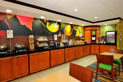 a fast food restaurant with wooden cabinets and a kitchen at Fairfield Inn & Suites Fresno Clovis in Clovis