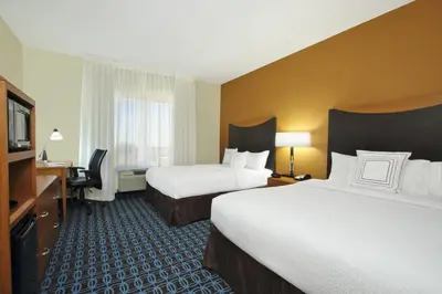 a hotel room with two beds and a television at Fairfield Inn & Suites Fresno Clovis in Clovis