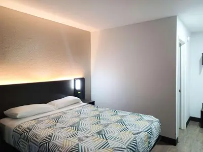 a bedroom with a large bed in a room at Motel 6-Fresno, CA - Blackstone North in Fresno