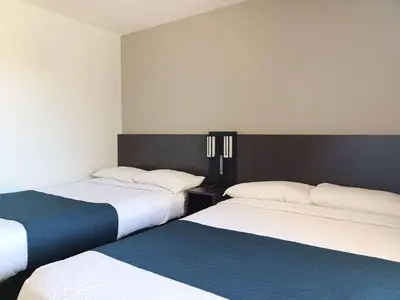 two beds sitting next to each other in a room at Motel 6-Fresno, CA - Blackstone North in Fresno