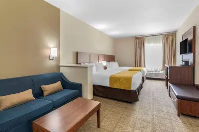 a hotel room with a bed and a couch at Comfort Suites Tulare Sequoia Gateway in Tulare
