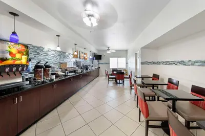 a dining room with tables and chairs in a restaurant at Comfort Suites Tulare Sequoia Gateway in Tulare