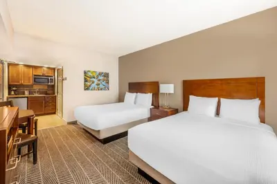 a hotel room with two beds and a kitchen at Hilton Vacation Club Lake Tahoe Resort South in South Lake Tahoe