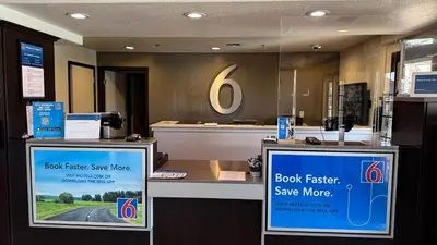 a store with two signs in front of a counter at Motel 6-Lodi, CA in Lodi