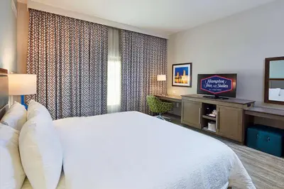 a hotel room with a bed and a television at Hampton Inn & Suites Sacramento at CSUS in Sacramento