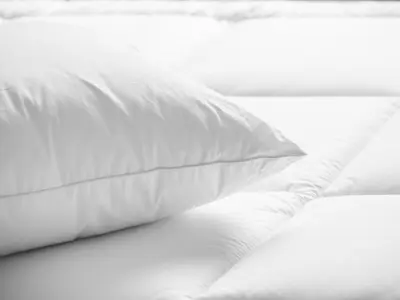 a white pillow sitting on top of a bed at SpringHill Suites by Marriott Modesto in Modesto