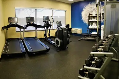 a gym with several tread machines in a room at SpringHill Suites by Marriott Modesto in Modesto
