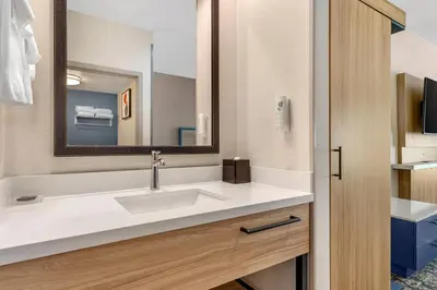a bathroom with a sink and a mirror at Country Inn & Suites by Radisson, Modesto-Salida in Modesto