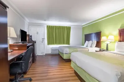 a hotel room with two beds and a desk at Motel 6-Kingsburg, CA in Kingsburg