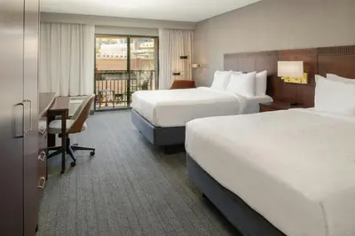 a hotel room with two beds and a desk at Courtyard Carson City in Carson City