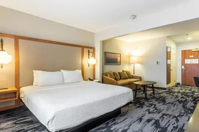 a hotel room with a bed and a couch at Fairfield Inn & Suites Rancho Cordova in Rancho Cordova