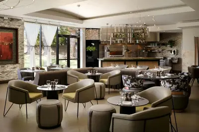 a restaurant with couches and tables and chairs at Sacramento Marriott Rancho Cordova in Rancho Cordova