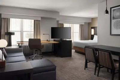 a hotel room with a bed and a desk and a room at Residence Inn by Marriott Stockton in Stockton