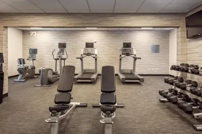 a gym with several treadmills and exercise bikes at Courtyard by Marriott Stockton in Stockton