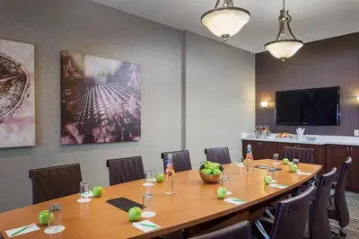 a conference room with a long wooden table and chairs at Courtyard by Marriott Stockton in Stockton