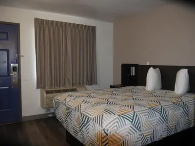 a bedroom with a large bed and a window at Motel 6-Sacramento, CA - South Sacramento and Elk Grove in Sacramento