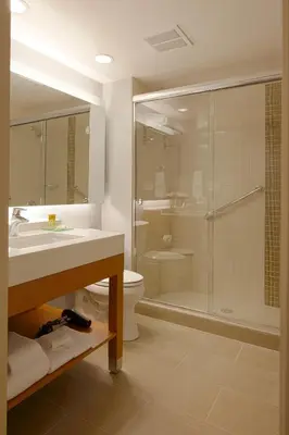 a bathroom with a shower and a sink and a toilet at Hyatt Place Delano in Delano