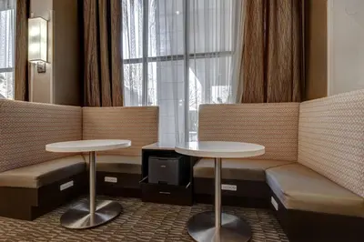 a waiting room with two tables and a couch at Hampton Inn & Suites Tulare in Tulare