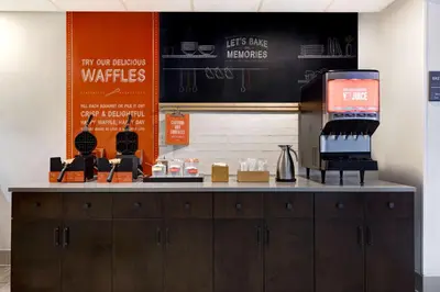 a counter in a coffee shop with a counter at Hampton Inn & Suites Tulare in Tulare