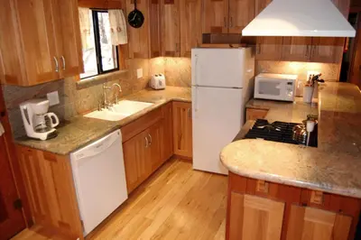 a kitchen with a white refrigerator and a sink at 26 Deer Den in North Wawona