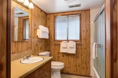 a bathroom with a sink and a toilet and a window at 24B Birds Eye View in Wawona