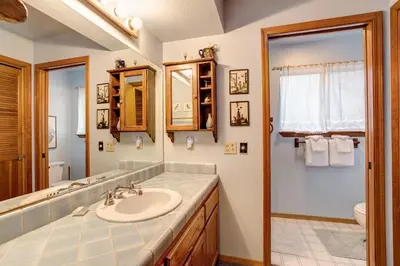 a bathroom with a sink and a mirror at 2B Quail Meadow in Wawona
