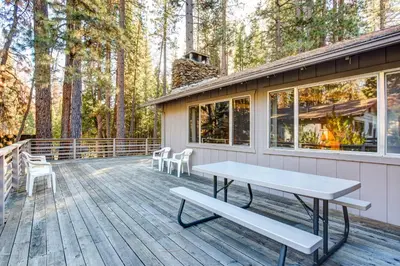 a deck with a picnic table and chairs on it at 2B Quail Meadow in Wawona