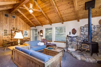 a living room with a couch and a fireplace at 2B Quail Meadow in Wawona