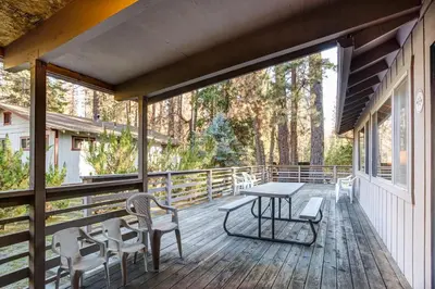 a screened porch with a table and chairs on it at 2B Quail Meadow in Wawona
