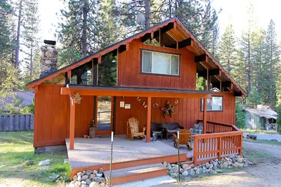 a house with a porch and a deck at 6B Meadow View in Wawona