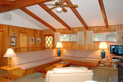 a living room with a couch and a tv at 99 Yosemite Mountain Lodge in Wawona