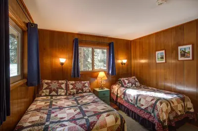 a bedroom with two beds and a window at 11B Sequoia House in Wawona