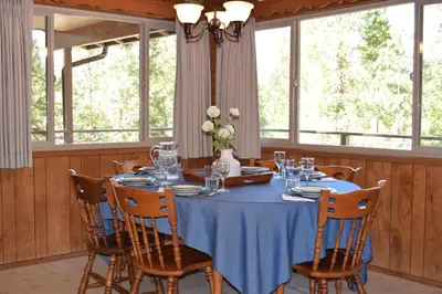a dining room with a blue table and chairs at 11B Sequoia House in Wawona