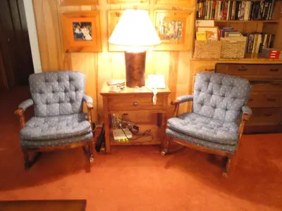 two chairs sitting next to a table with a lamp at 39 River Song in North Wawona