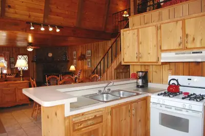 a kitchen with a sink and a stove top oven at 46R Manzanita Lodge in Wawona