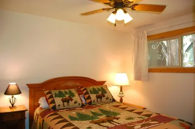 a bedroom with a bed and a ceiling fan at 78 Ox Yoke in Wawona