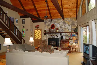 a living room with a couch and a fireplace at 50 Spindlers Chalet in Wawona