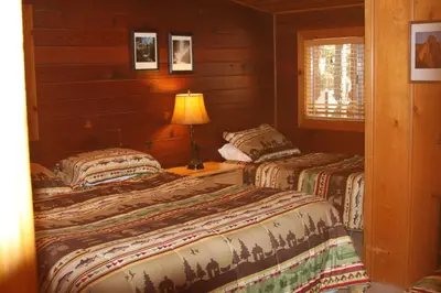 a bedroom with two beds and a lamp on a table at 76 Howards Retreat in North Wawona