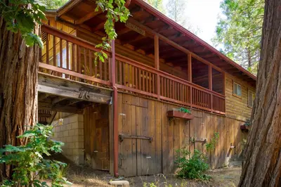 a large wooden house with a large wooden garage at 76 Howards Retreat in North Wawona