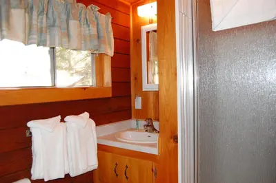 a small bathroom with a sink and a window at 76 Howards Retreat in North Wawona