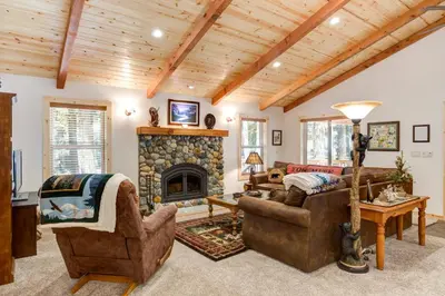 a living room with couches and a fireplace at 36 Larkspur Lair in Wawona