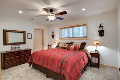 a bedroom with a bed and a ceiling fan at 36 Larkspur Lair in Wawona