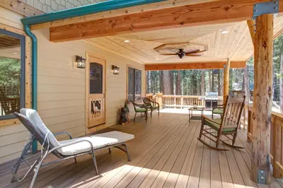 a screened porch with chairs and a ceiling fan at 36 Larkspur Lair in Wawona